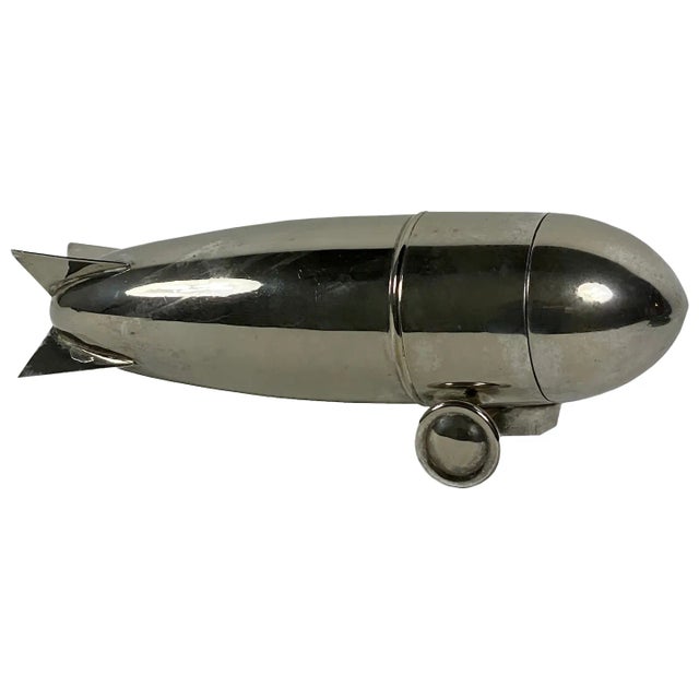 A silverplate cocktail shaker is an ideal accessory for any mid-century bar. This one with its rocket shape and ability to...