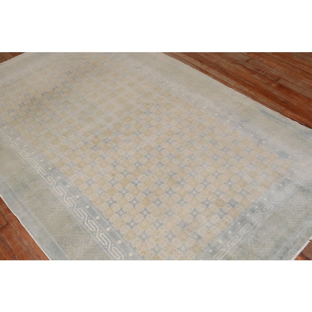 an intermediate size muted Chinese Rug from the middle of the 20th century Measures: 4'11'' x 7'9''.