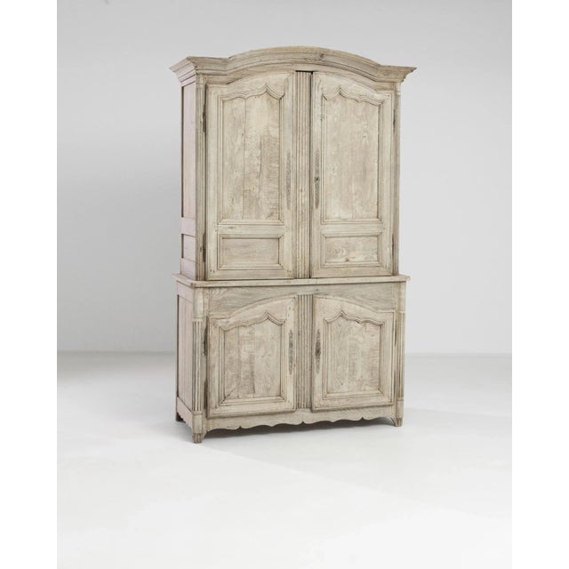 A 19th century wooden cabinet produced in France. Standing on fluted bracket feet, this large two-case cabinet displays a...
