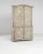 A 19th century wooden cabinet produced in France. Standing on fluted bracket feet, this large two-case cabinet displays a...