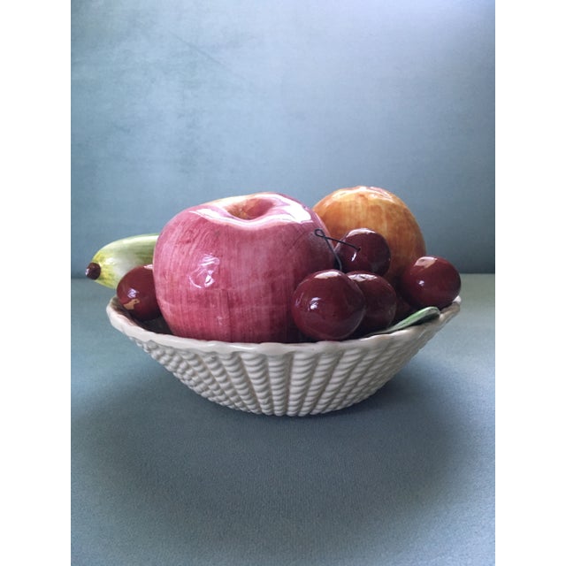 A collection of richly toned & beautifully shaded Italian ceramic faux fruit consisting of cherries, an apple, an orange...