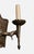 This is a vintage wrought iron wall sconce with a Gothic aesthetic. The backplate has an irregular, hand-hammered...