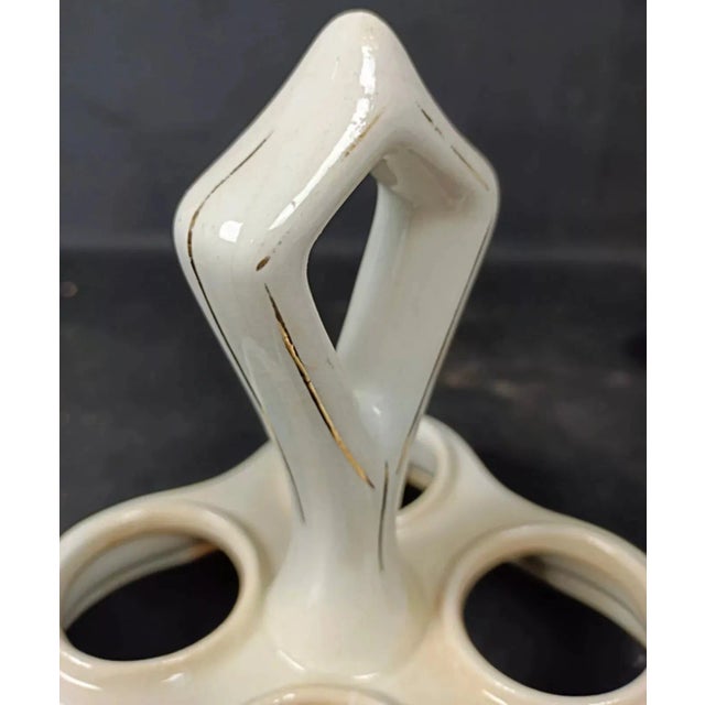 This vintage condiment set, featuring a lovely floral "China" design, is crafted from glass and faience, providing a...