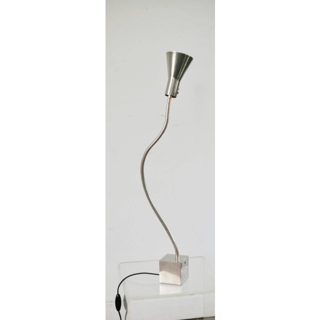 Steel lamp 70. Attributed to Michel Boyer Cubic base in polished steel. flexible and steel conical reflector. Electricity...