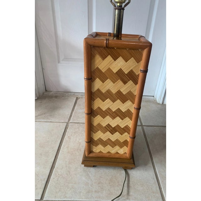 Bring effortless mid-century warmth to your space with this vintage faux bamboo and woven rattan table lamp. Featuring a...
