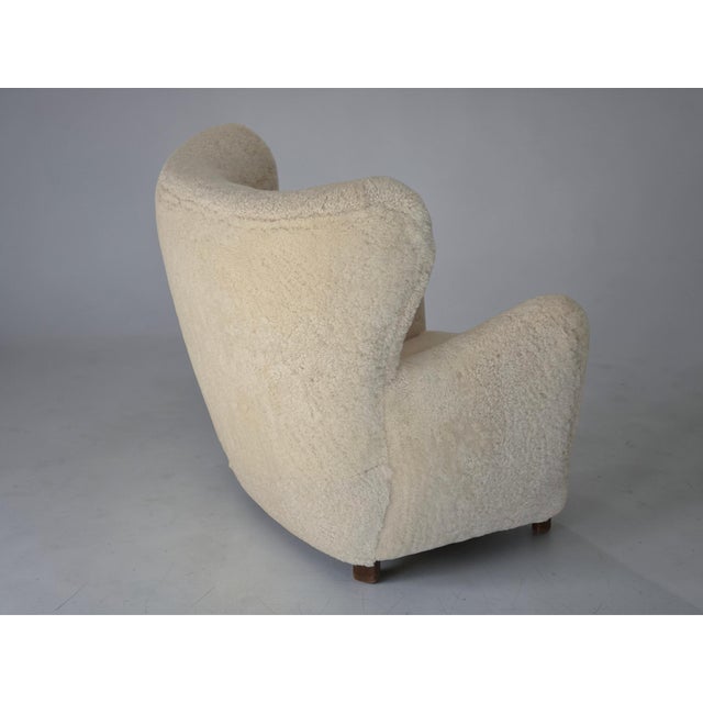1960s, Danish design. Renovated-reupholstered armchair. Quality New Zealand genuine sheepskin "Canberra". Beech legs,...