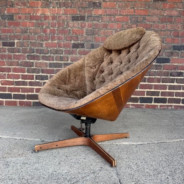 Space Age meets cozy mid-century modernity in this Cone Plycraft swivel chair. The wooden cone shaped base is upholstered...