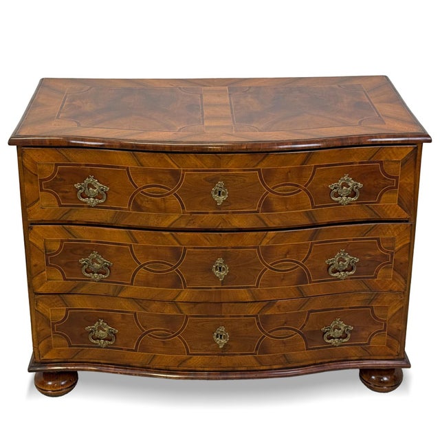An exceptional Late Baroque chest of drawers dating from circa 1790–1800, distinguished by its gently shaped front and...