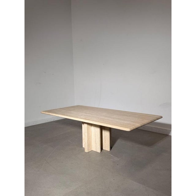 Striking coffee table crafted entirely from natural travertine, featuring a beautifully veined rectangular top with softly...