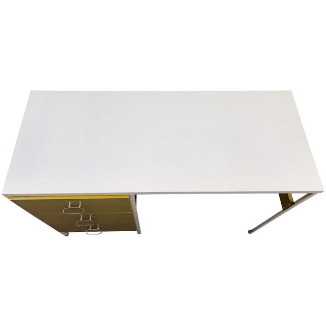 George Nelson for Herman Miller Steel Frame Desk featuring a steel frame, wooden drawers, white laminate top, and avocado...