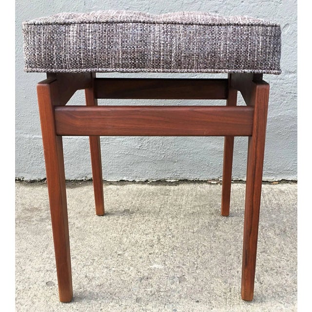 Beautiful walnut stool by Jens Risom. Newly upholstered in charcoal and blue woven tweed.