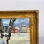 Original oil painting signed "Millie Housel" lower right: winter village scene with a large snow-banked tree in the...