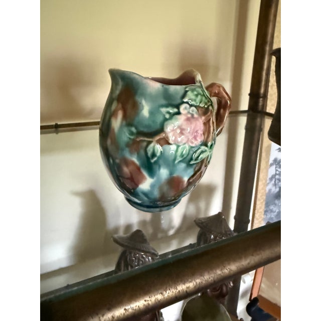 Beautiful vintage majolica-style art pottery creamer or small pitcher featuring richly molded floral relief with soft pink...