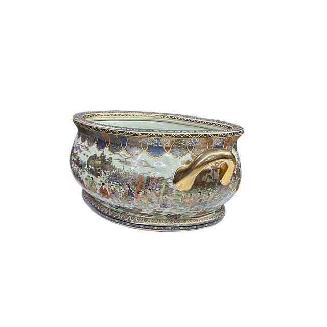 This is an ornate, oval-shaped ceramic basin, likely a decorative planter or fish bowl, designed in the tradition of...