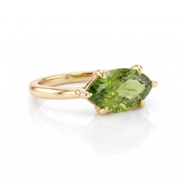 Embrace fresh, lively color with this charming peridot marquise ring. The vibrant olive-green gemstone is securely cradled...