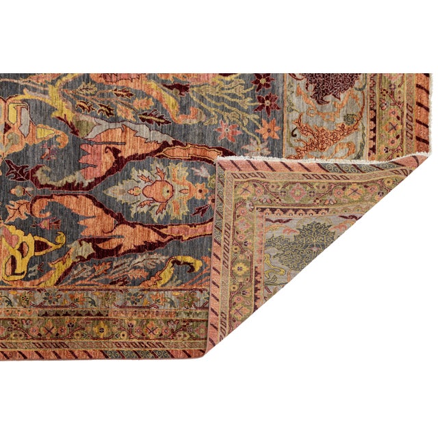 Inspired by classic Persian Bidjar designs, this hand-knotted wool rug features a richly saturated palette of red, navy,...