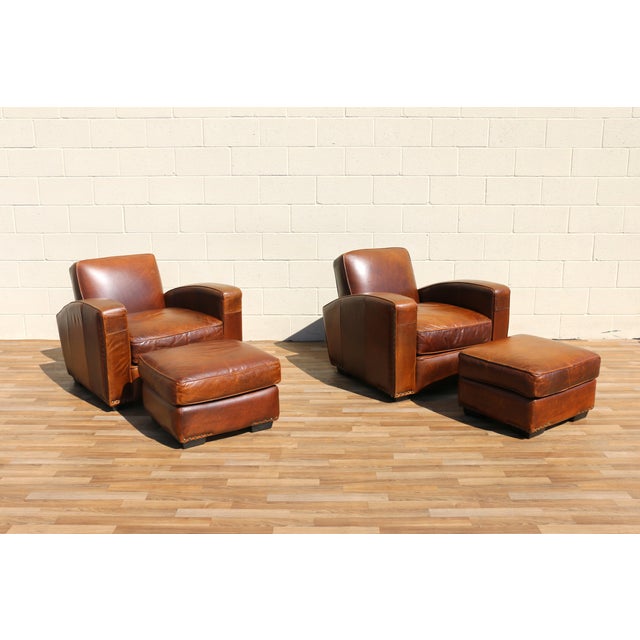 Wonderful vintage pair of Art Deco Revival club chairs with matching ottomans, circa 1980s. Upholstered in beautifully...