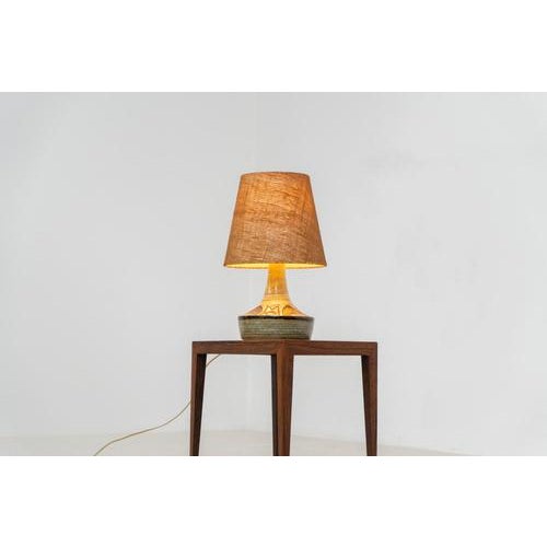 Ceramic table lamp by Søholm for Bornholmsk (Denmark, 1960s). This lamp offers a refined blend of beautiful textures and...