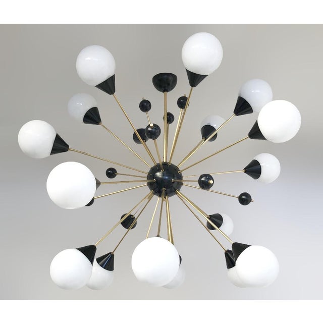 Italian midcentury style Sputnik chandelier with 18 matte white Murano glass globes, mounted on unlacquered natural brass...