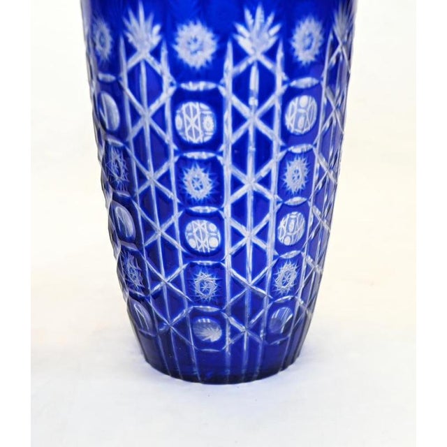 An attractive pair of tall cobalt blue glass vases with gently tapering bodies and circular rims The rich blue surface is...