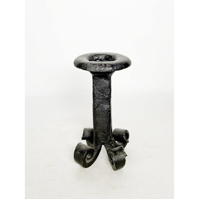 Tripod candlestick in cast iron with a brutalist design, made in France in the 1960s. This sculptural piece in black cast...