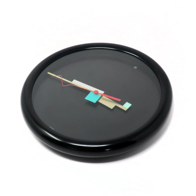 A truly stunning and rare Memphis Milano inspired wall clock made in Japan by Citizen. Black case, black face with a dot...