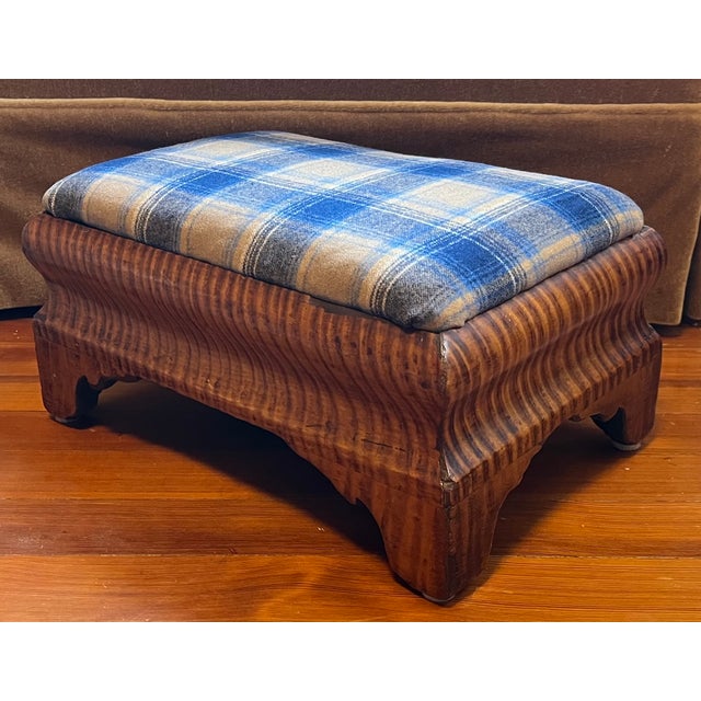 Antique 19th century American Classical foot stool in highly figured tiger maple, circa 1830. Upholstered with blue plaid...