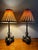 Beautiful vintage pair of bronze swan table lamps on marble bases by Theodore Alexander. Each lamp features three swans...