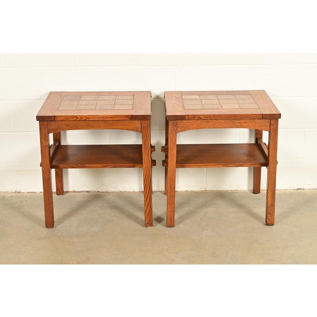 A beautiful pair of Mission or Arts & Crafts style two-tier occasional side tables By L. & J.G. Stickley USA, 1996 Carved...