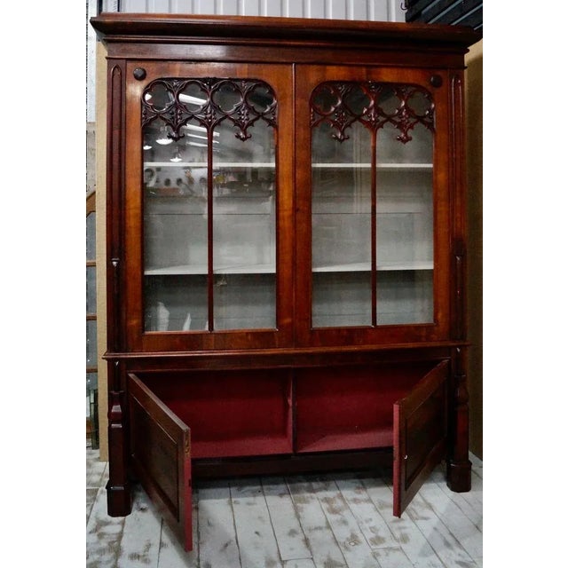 Large Victorian Rosewood Gothic Bookcase. With its moulded cornice above a pair of glazed panel doors with applied trefoil...