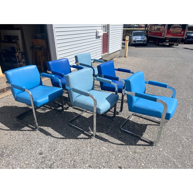 Very fine quality arm chairs having leather-like upholstery on steel frames. Three shades of blue. Width 23.5" Depth 24"...