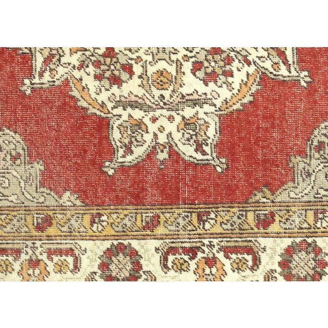 Expertly handwoven in the Oushak region of Western Turkey, this Vintage Turkish Oushak Rug features a traditional design...