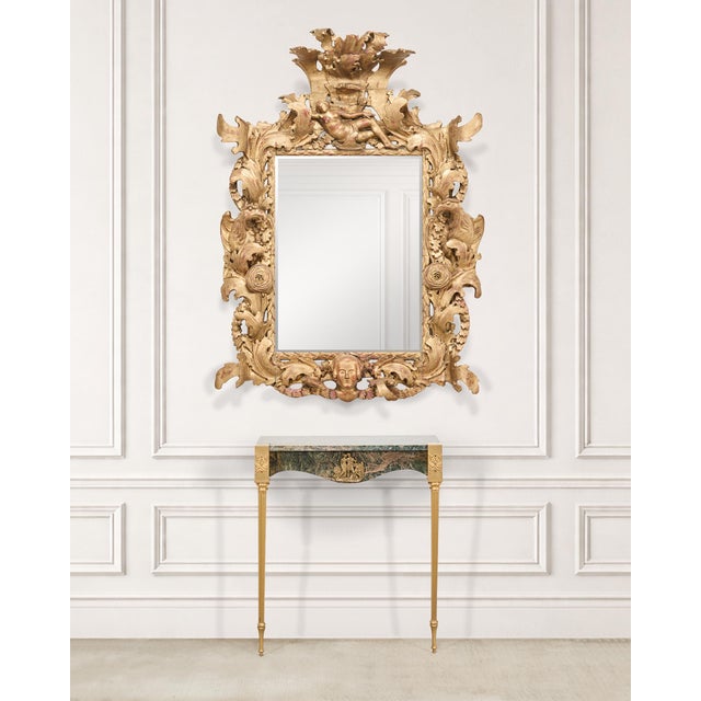 An imposing finely carved early 18th century Italian Baroque giltwood mirror frame or picture frame featuring a dramatic...