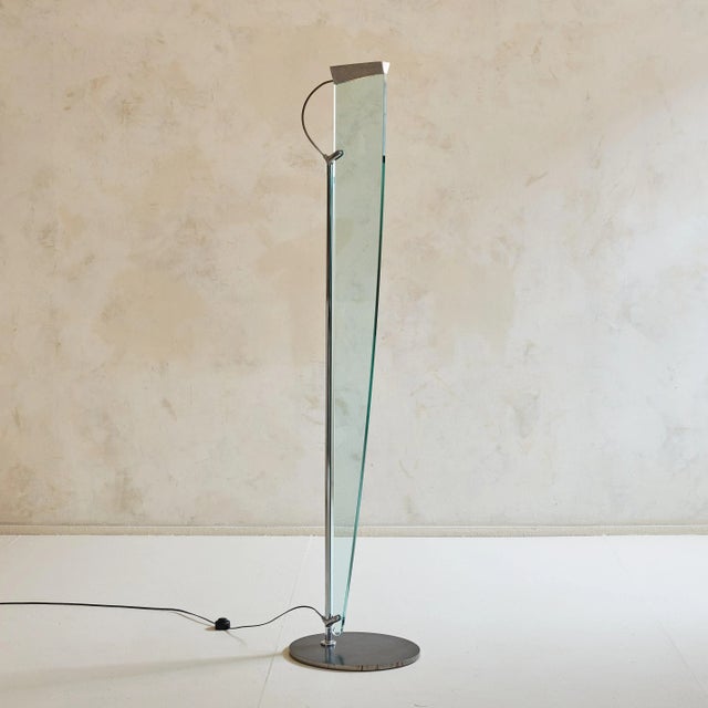 The 'Naos Terra' floor lamp, designed by Carlo Forcolini for Nemo Italianaluce in the 1980s, features a polished chrome...