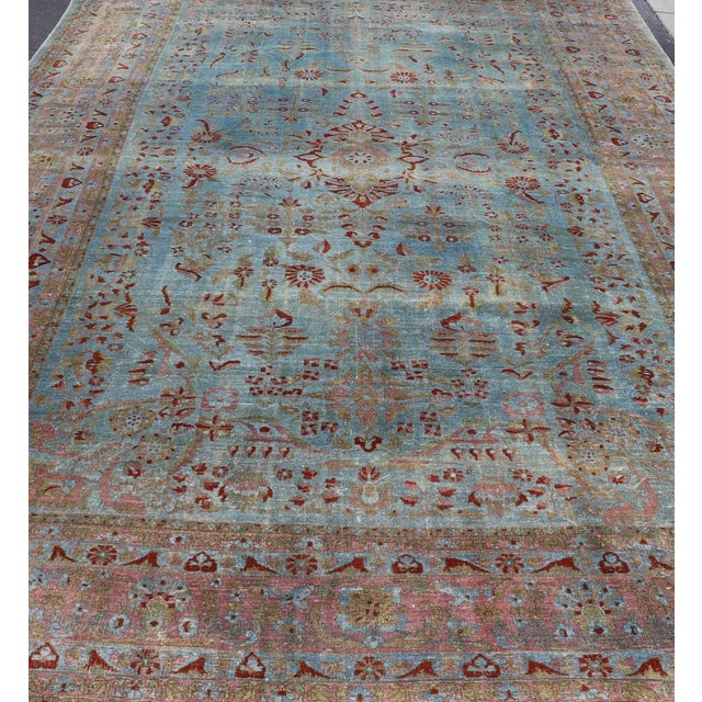 Blue background antique Persian Sarouk rug with red and acid green florals. Keivan Woven Arts / rug L11-0305, country of...