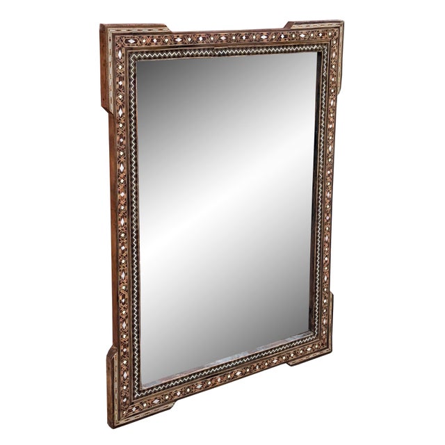 A stunning example of early 20th-century craftsmanship, this mirror features natural wood inlaid with delicate mother-of-...