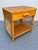Charming vintage bamboo and rattan nightstand featuring a warm honey-toned finish and beautiful lattice detailing along...