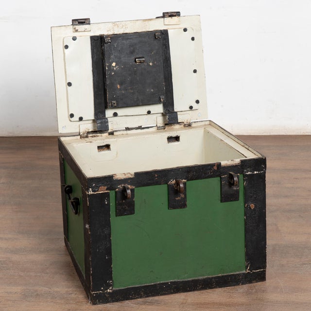 Late 19th-century iron money lock box constructed of heavy iron with black painted corners and trim over a green ground....