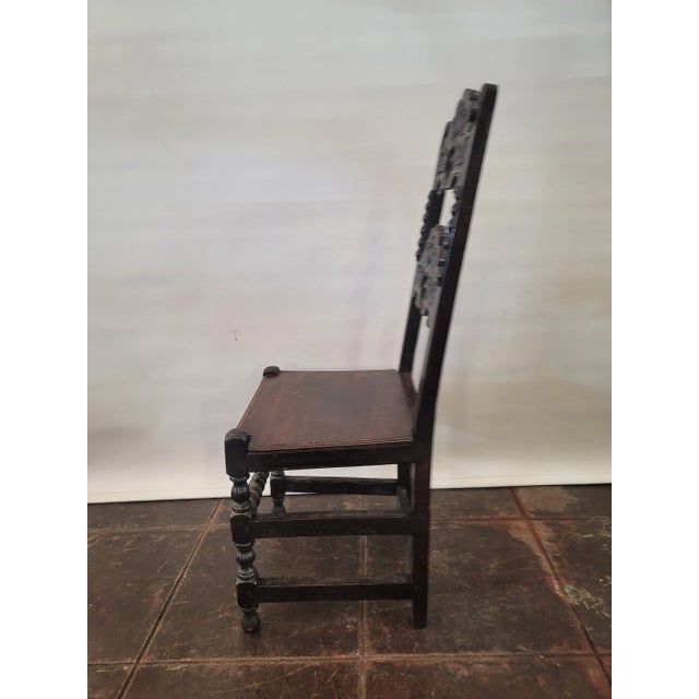 A very heavy oak carved antique Charles II, Lancashire chair. Has been fumigated for woodworm which would be expected for...