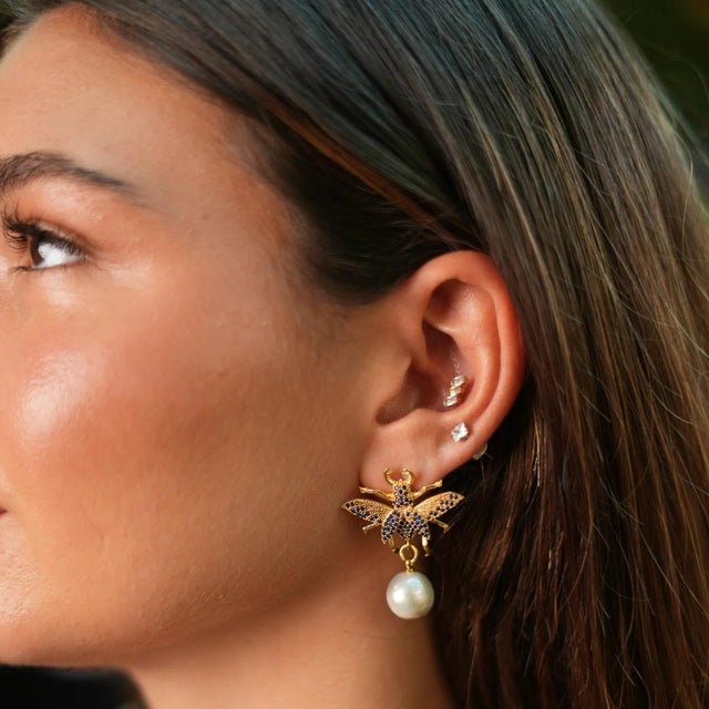 Make a bold statement with the Divine Connection Queen Bee Turquoise & Gold Chunky Earrings, crafted in 24k gold plating...