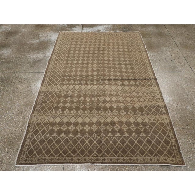 A vintage Turkish Sivas accent rug. Both the abrashed field and border display a small, repeating diamond pattern with...