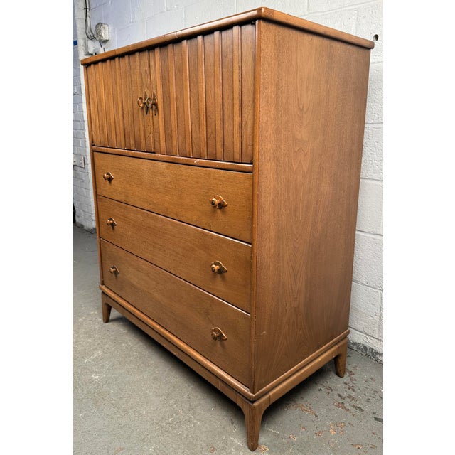 Classic mid-century modern highboy dresser by the renowned Broyhill Premier Division, showcasing the clean lines and...