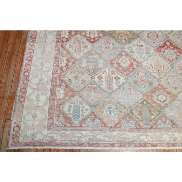 A room size Geometric Persian Bakhtiari rug with an all-over garden design in rustic / earth tone colors throughout...