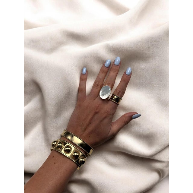 Gleaming ring of Mother of Pearl in a high shine gold. Adjustable size