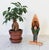 Vintage hand-carved wooden figurine of a man in a plaid shirt, smoking a pipe and carrying a canoe. Some minor age wear.