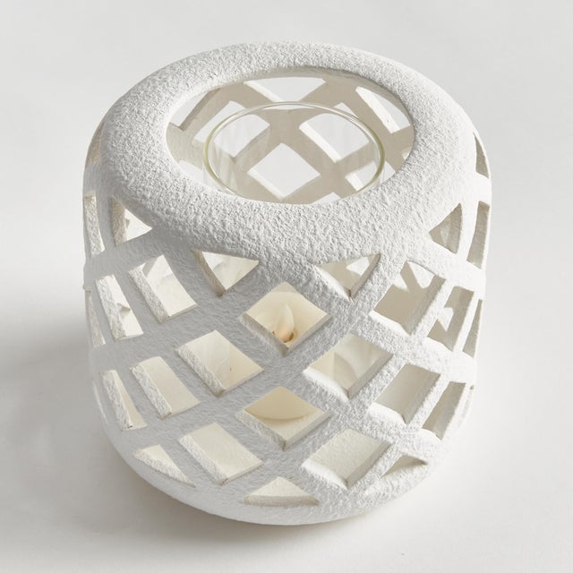 Expertly crafted from hand cut ceramic strips, and finished in a brightWhite glaze, this hurricane lets all the light...