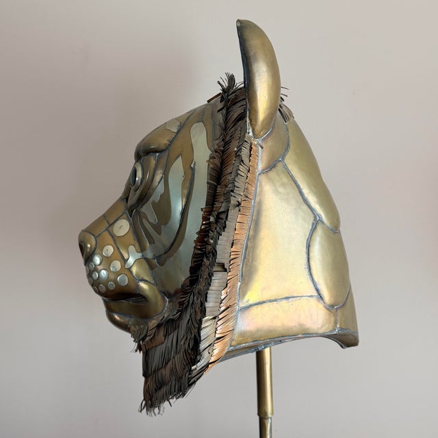 A large brass and copper tiger head sculpture by Sergio Bustamante, signed and numbered 88/100. The head is mounted on a...