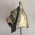 A large brass and copper tiger head sculpture by Sergio Bustamante, signed and numbered 88/100. The head is mounted on a...