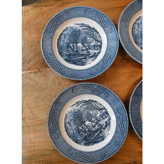 A set of four vintage Currier & Ives dinner plates featuring The Old Grist Mill from the Currier & Ives collection...