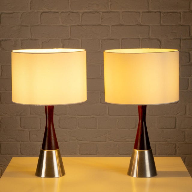 Pair of solid rosewood and aluminium table lamps designed and manufactured by Bergboms, Sweden, 1950s. In very good...